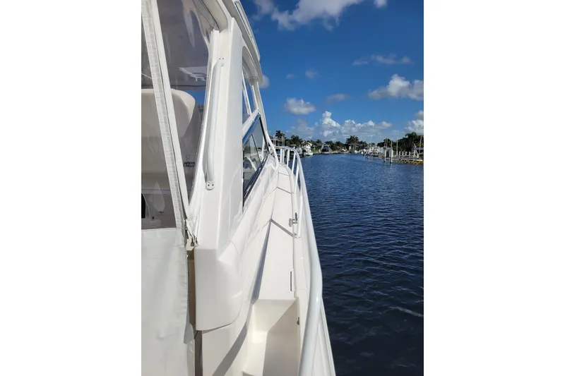 Slide: The Image of 2016 Intrepid 475 Sport Yacht on calm water under a clear blue sky. - 18