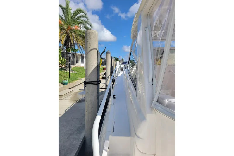 Slide: The Image of 2016 Intrepid 475 Sport Yacht docked, featuring sleek design and clear skies. - 19