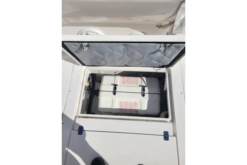 Slide: The Image of Open storage compartment on 2016 Intrepid 475 Sport Yacht, showcasing interior equipment. - 2