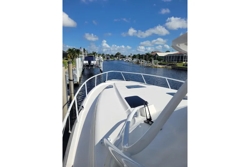 Slide: The Image of 2016 Intrepid 475 Sport Yacht cruising on a sunny day, canal view. - 20