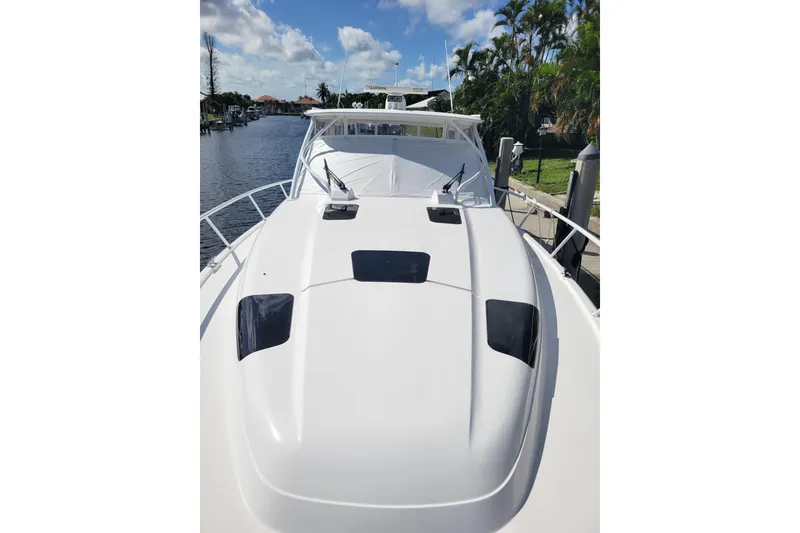 Slide: The Image of 2016 Intrepid 475 Sport Yacht on a sunny day, docked by a canal. - 22