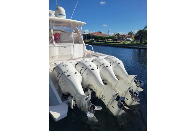 Slide: The Image of 2016 Intrepid 475 Sport Yacht with four Yamaha outboard engines docked by waterfront homes. - 24