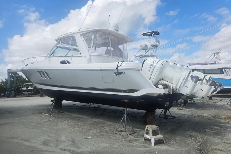 Slide: The Image of 2016 Intrepid 475 Sport Yacht on stands, featuring triple Yamaha outboard engines. - 25