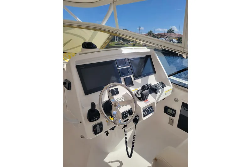 Slide: The Image of Helm of 2016 Intrepid 475 Sport Yacht with modern navigation equipment and steering wheel. - 6