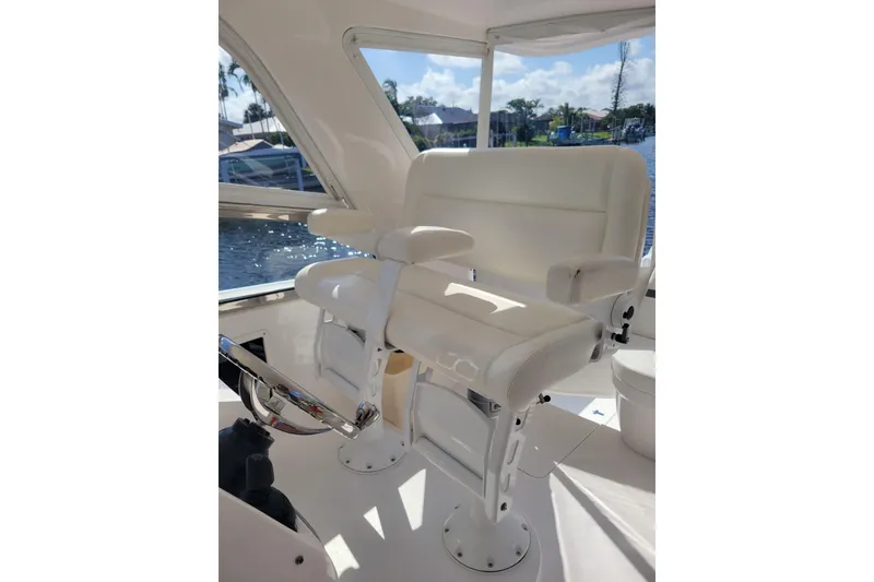 Slide: The Image of Luxurious white seating on 2016 Intrepid 475 Sport Yacht, with scenic waterfront view. - 7