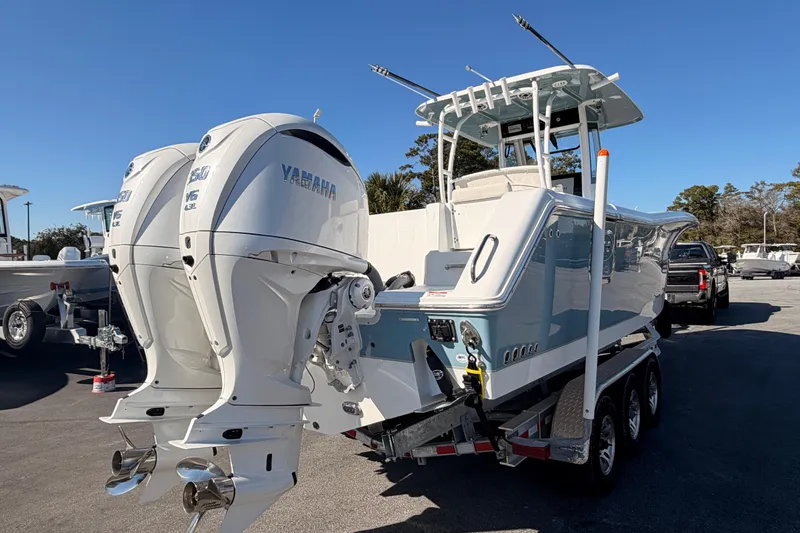 Slide: The Image of 2025 Sea Hunt Gamefish 30 Coffin Box boat with dual Yamaha engines on a trailer. - 2
