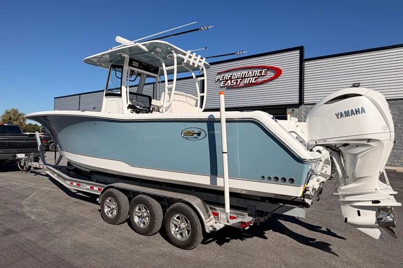 Slide: The Image of 2025 Sea Hunt Gamefish 30 Coffin Box boat on trailer, featuring Yamaha engines. - 3