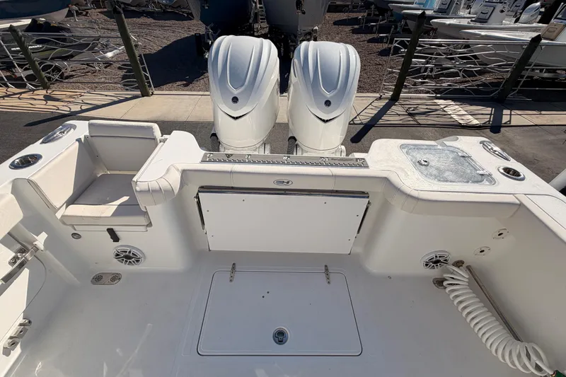 Slide: The Image of 2025 Sea Hunt Gamefish 30 Coffin Box boat interior with dual engines and seating area. - 5