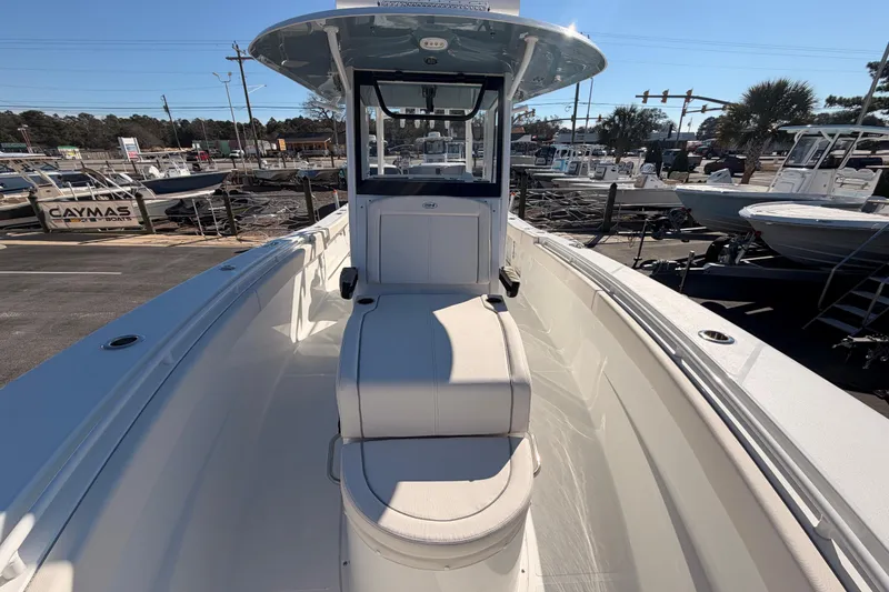 Slide: The Image of 2025 Sea Hunt Gamefish 30 Coffin Box boat, sleek design, parked at marina. - 9