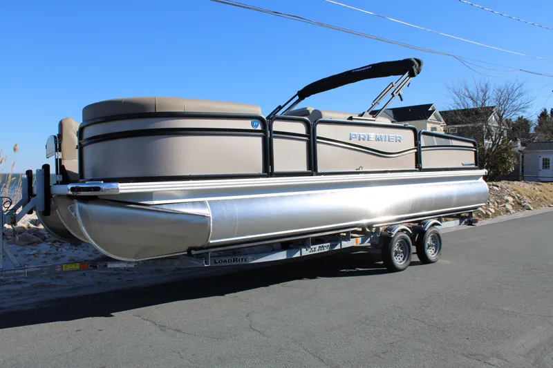 The Image of 2026 Premier 230 Sunsation Angler 2pt pontoon boat on trailer, parked on road. - 0