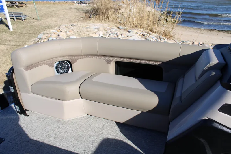 Slide: The Image of 2026 Premier 230 Sunsation Angler 2pt boat interior with beige seating and speaker. - 12