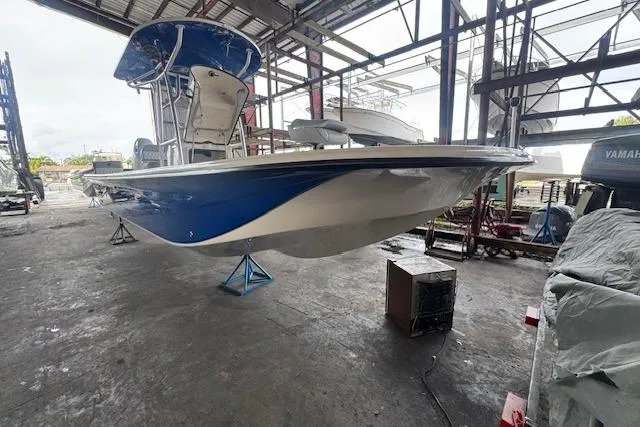 Slide: The Image of 2026 Carolina Skiff 25 LS boat in a warehouse, elevated on stands. - 17