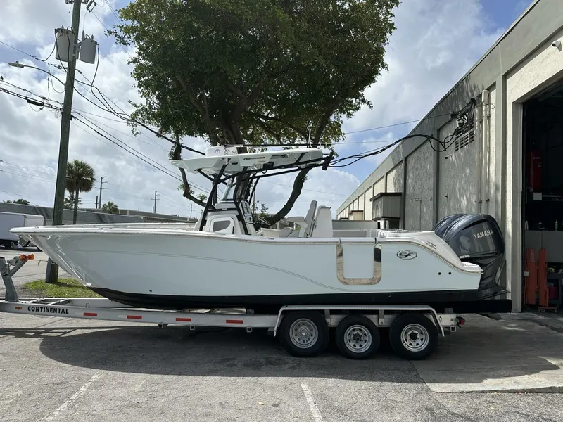 Slide: The Image of 2022 Sea Fox 288 Commander boat on trailer, parked outside a building. - 1