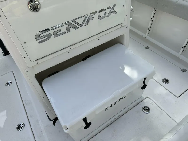 Slide: The Image of 2022 Sea Fox 288 Commander boat interior with storage compartment and cooler. - 17