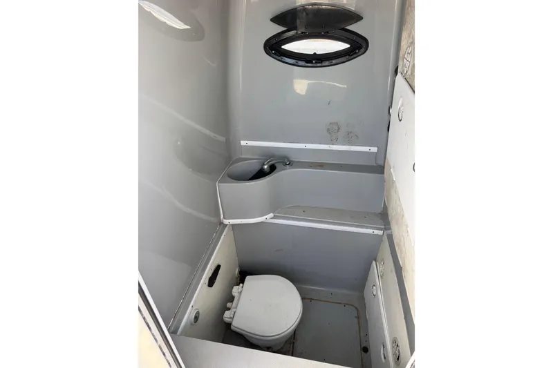 Slide: The Image of 2016 Contender 35 ST boat interior bathroom with compact toilet and sink. - 10