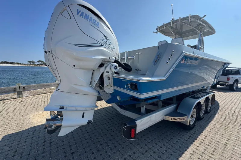 Slide: The Image of 2016 Contender 35 ST boat with Yamaha engine on trailer by the water. - 3