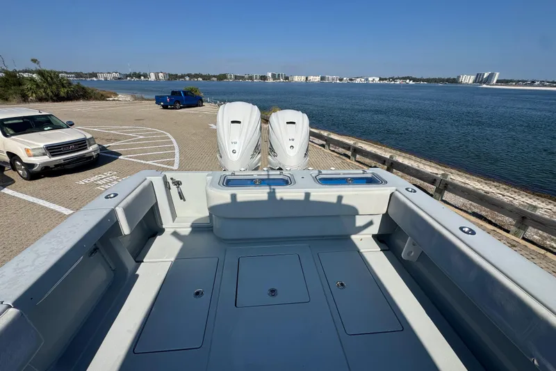 Slide: The Image of 2016 Contender 35 ST boat with dual engines at a scenic waterfront dock. - 6