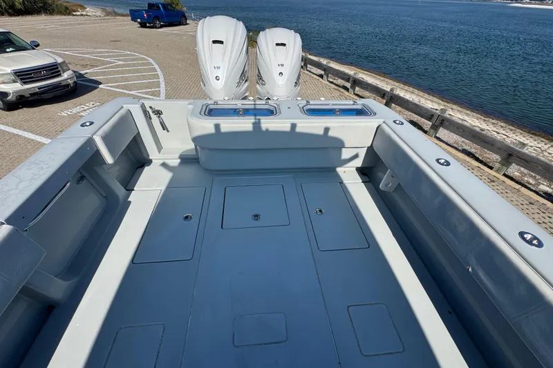 Slide: The Image of 2016 Contender 35 ST boat with twin V8 engines, parked by the waterfront. - 9