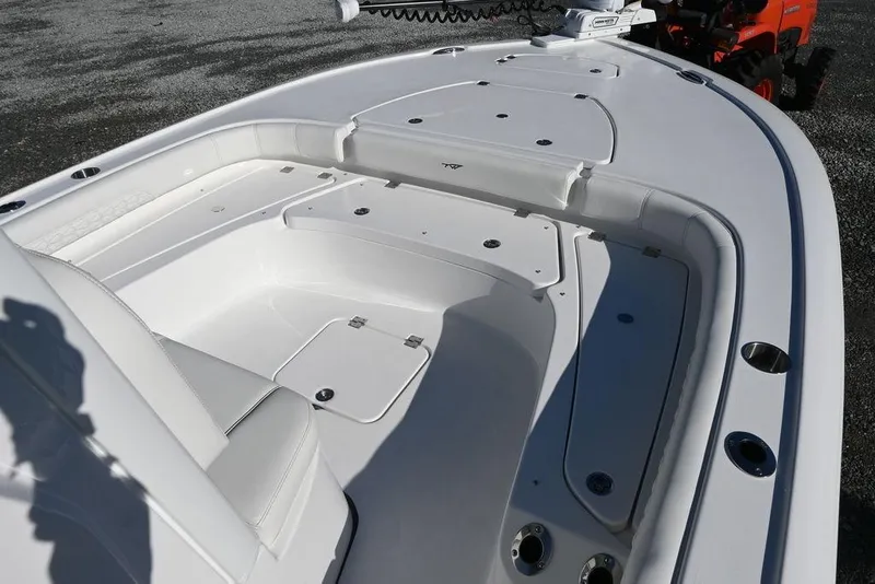 Slide: The Image of 2026 Tidewater 2500 Carolina Bay boat deck with seating and storage compartments. - 11