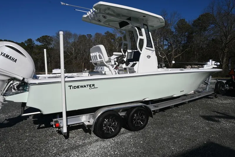 Slide: The Image of 2026 Tidewater 2500 Carolina Bay boat on trailer, featuring Yamaha engine, parked outdoors. - 2
