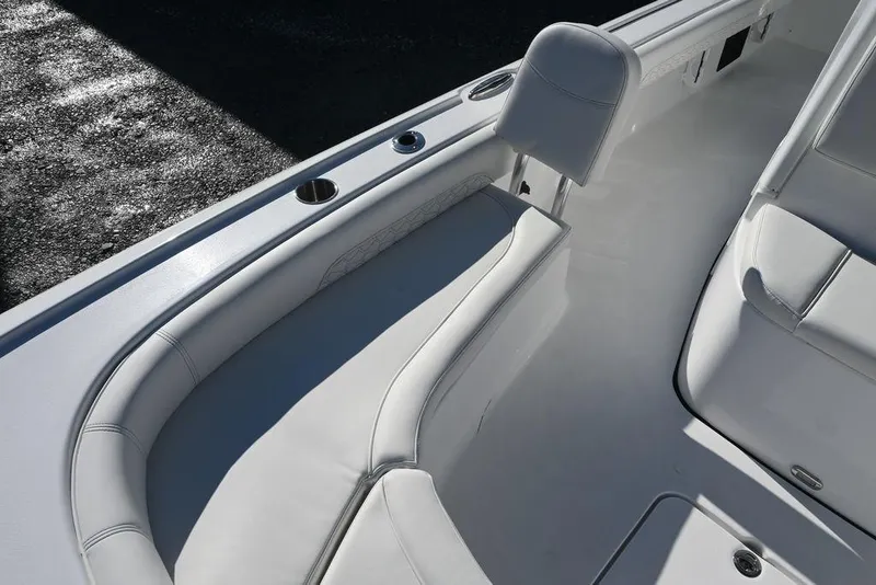 Slide: The Image of 2026 Tidewater 2500 Carolina Bay boat interior with white cushioned seating. - 20