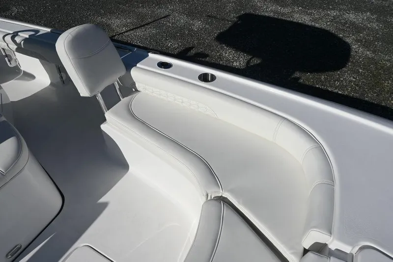 Slide: The Image of 2026 Tidewater 2500 Carolina Bay boat interior with white cushioned seating. - 23