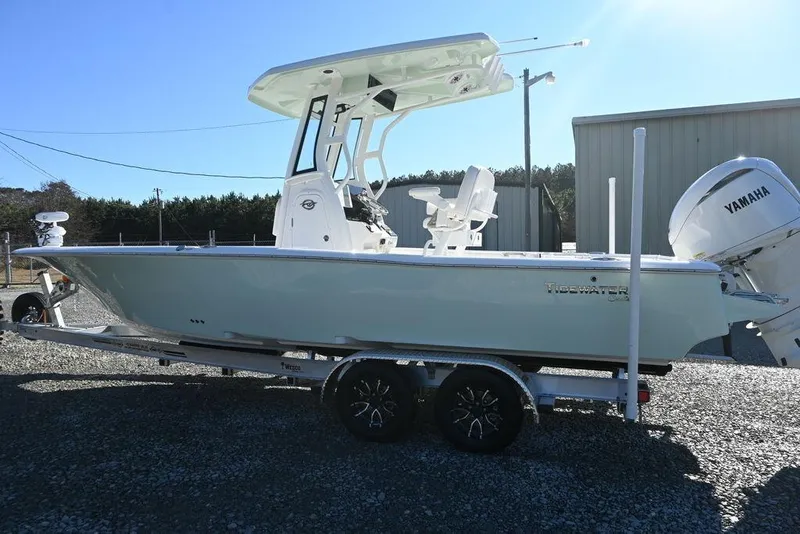 Slide: The Image of 2026 Tidewater 2500 Carolina Bay boat on trailer with Yamaha engine, parked outdoors. - 4