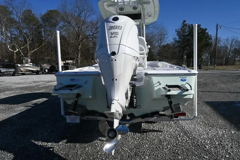 Slide: The Image of 2026 Tidewater 2500 Carolina Bay boat with powerful 300 V6 engine, parked outdoors. - 6