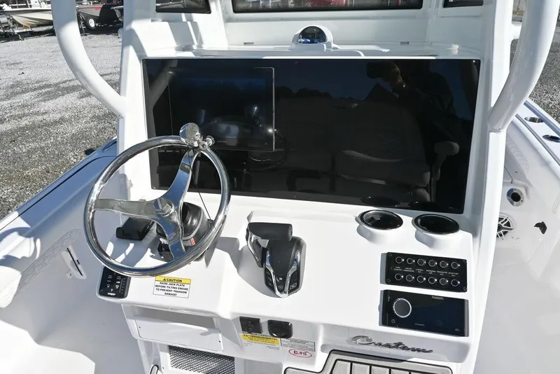 Slide: The Image of 2026 Tidewater 2500 Carolina Bay boat dashboard with steering wheel and controls. - 7