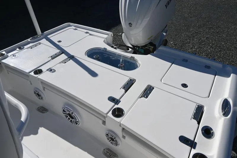 Slide: The Image of 2026 Tidewater 2500 Carolina Bay boat deck with storage compartments and Yamaha outboard motor. - 9