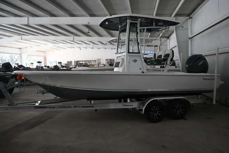 The Image of 2026 Tidewater 2110 Bay Max boat on trailer in indoor showroom. - 1