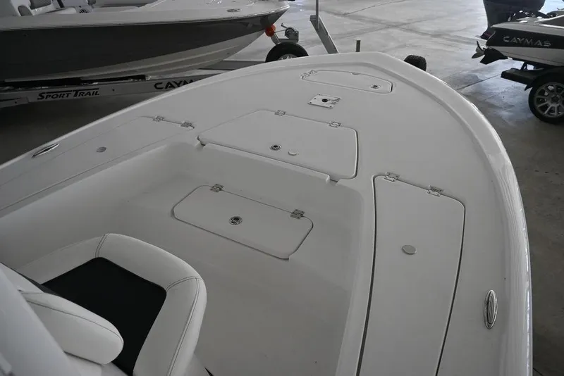 Slide: The Image of 2026 Tidewater 2110 Bay Max boat interior with storage compartments in a showroom. - 10