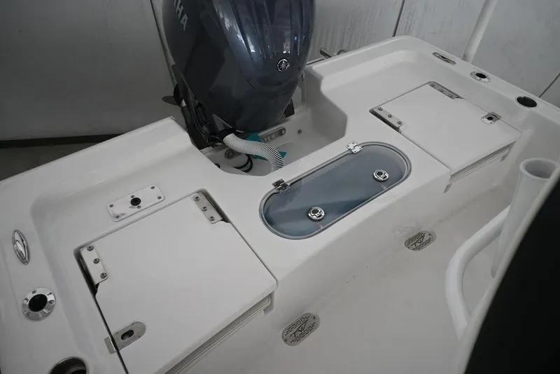 Slide: The Image of 2026 Tidewater 2110 Bay Max boat deck with Yamaha engine and storage compartments. - 12