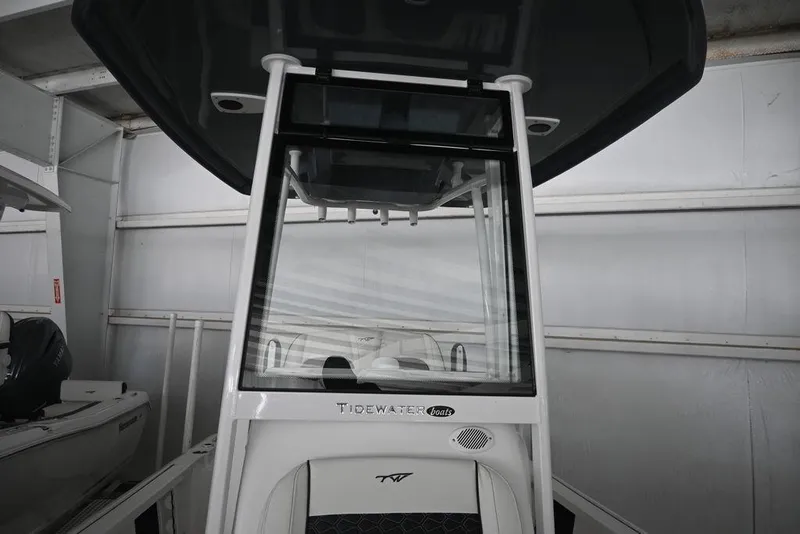 Slide: The Image of 2026 Tidewater 2110 Bay Max boat interior with console and seating in storage. - 16