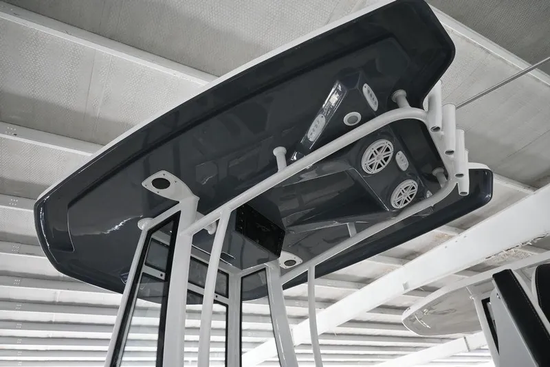 Slide: The Image of 2026 Tidewater 2110 Bay Max boat T-top with speakers and lights, viewed from below. - 3