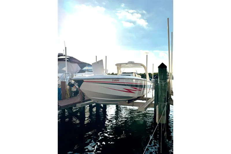 Slide: The Image of 2017 Cigarette 39' GTS boat docked on a lift, with a clear sky background. - 2