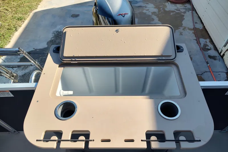 Slide: The Image of 2023 Sylvan Mirage 8520 Party Fish boat with open storage compartment and cup holders. - 12