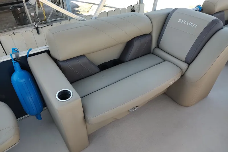 Slide: The Image of 2023 Sylvan Mirage 8520 Party Fish boat seating with cup holder and blue fender. - 13