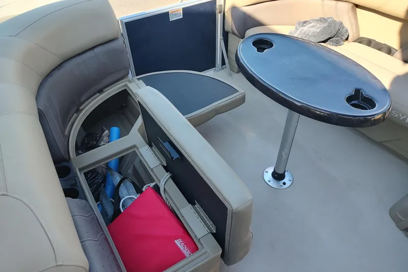 Slide: The Image of 2023 Sylvan Mirage 8520 Party Fish interior with seating, storage, and table. - 14