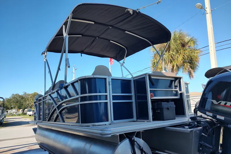 Slide: The Image of 2023 Sylvan Mirage 8520 Party Fish pontoon boat with canopy, docked outdoors. - 3