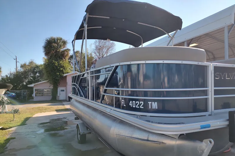 Slide: The Image of 2023 Sylvan Mirage 8520 Party Fish pontoon boat with canopy, parked outdoors. - 5