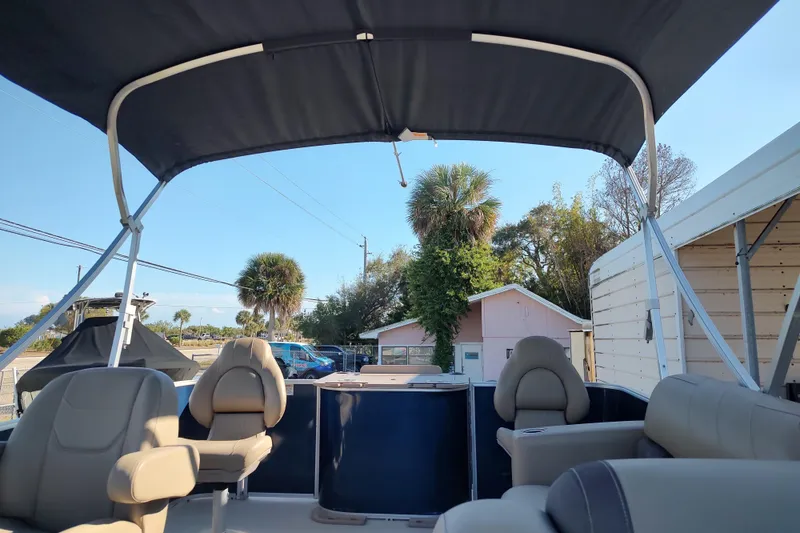 Slide: The Image of 2023 Sylvan Mirage 8520 Party Fish pontoon boat interior with canopy and seating. - 8