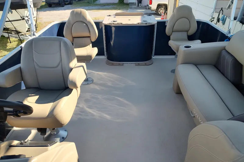 Slide: The Image of 2023 Sylvan Mirage 8520 Party Fish interior with beige seating and spacious layout. - 9