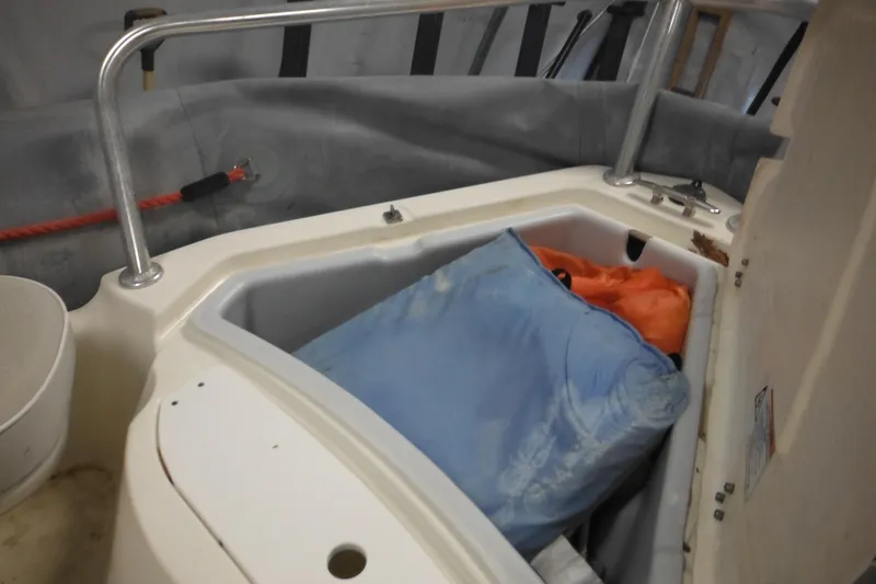 Slide: The Image of 2014 Zodiac Pro 550 boat storage compartment with bags inside. - 12
