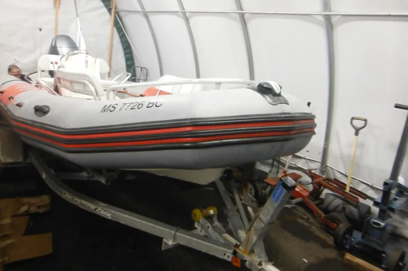Slide: The Image of 2014 Zodiac Pro 550 inflatable boat on trailer in storage facility. - 13