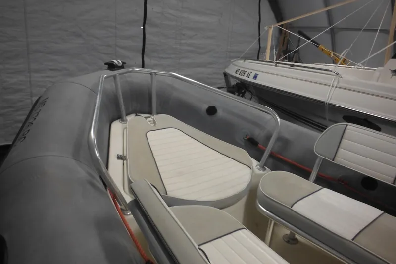Slide: The Image of 2014 Zodiac Pro 550 inflatable boat interior with seating, stored indoors. - 15