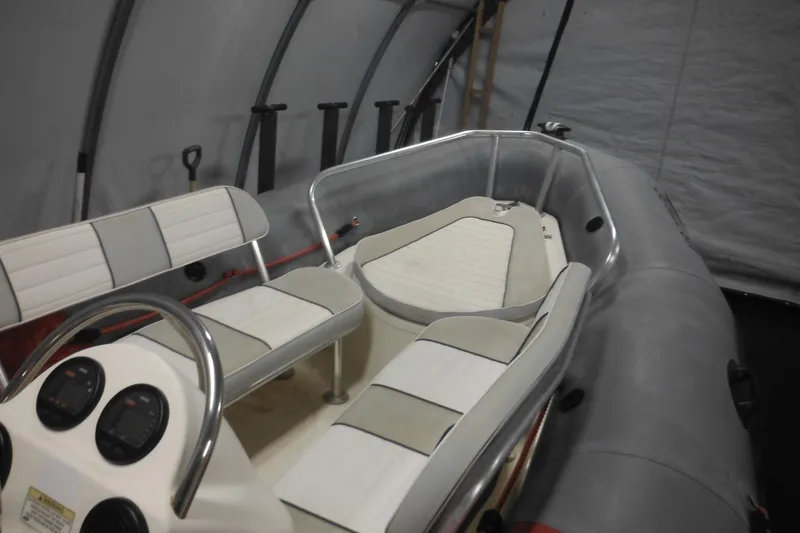 Slide: The Image of 2014 Zodiac Pro 550 inflatable boat interior with seating and control panel. - 16