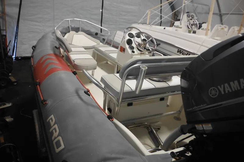Slide: The Image of 2014 Zodiac Pro 550 inflatable boat with Yamaha outboard motor in storage. - 4