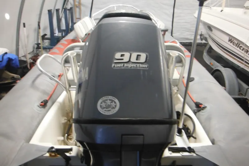 Slide: The Image of 2014 Zodiac Pro 550 boat with 90 HP fuel injection engine in storage. - 5