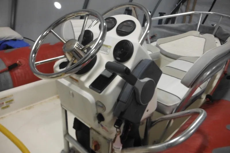 Slide: The Image of 2014 Zodiac Pro 550 boat interior with steering wheel and controls. - 7